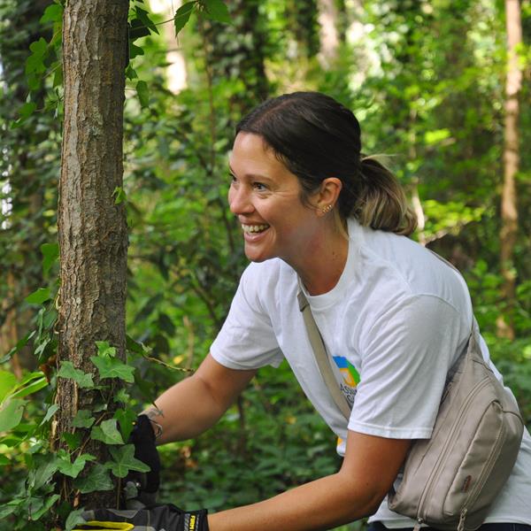 Image of Assurant employee smiling while doing community work outdoors