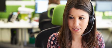 Women with headset working at computer
